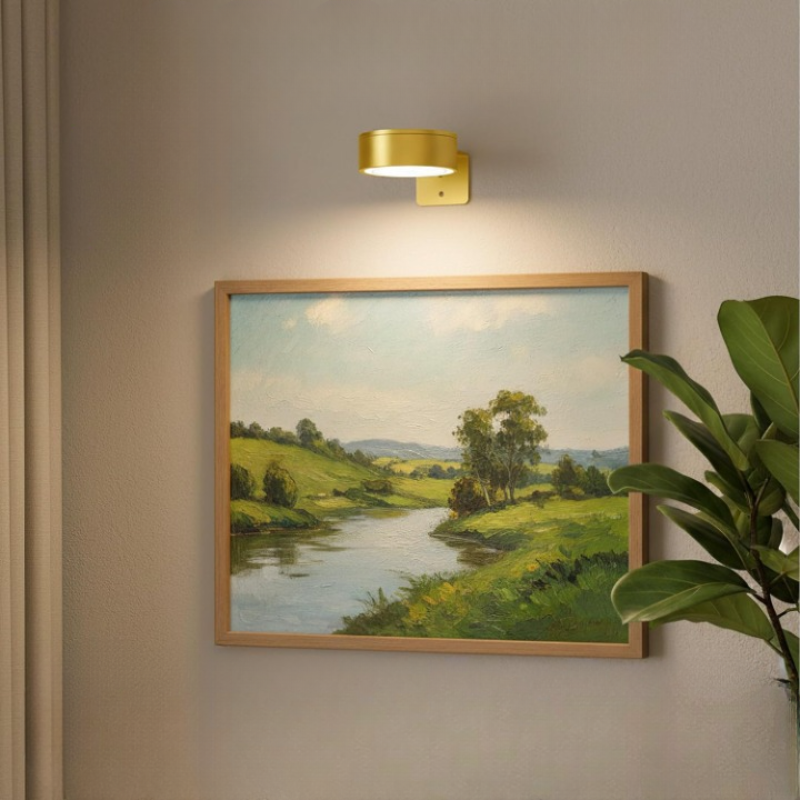 Wireless wall-mounted picture light above framed artwork with remote control