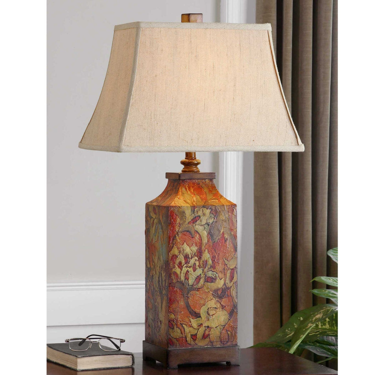 Floral table lamp with beige tapered shade and colourful patterned base