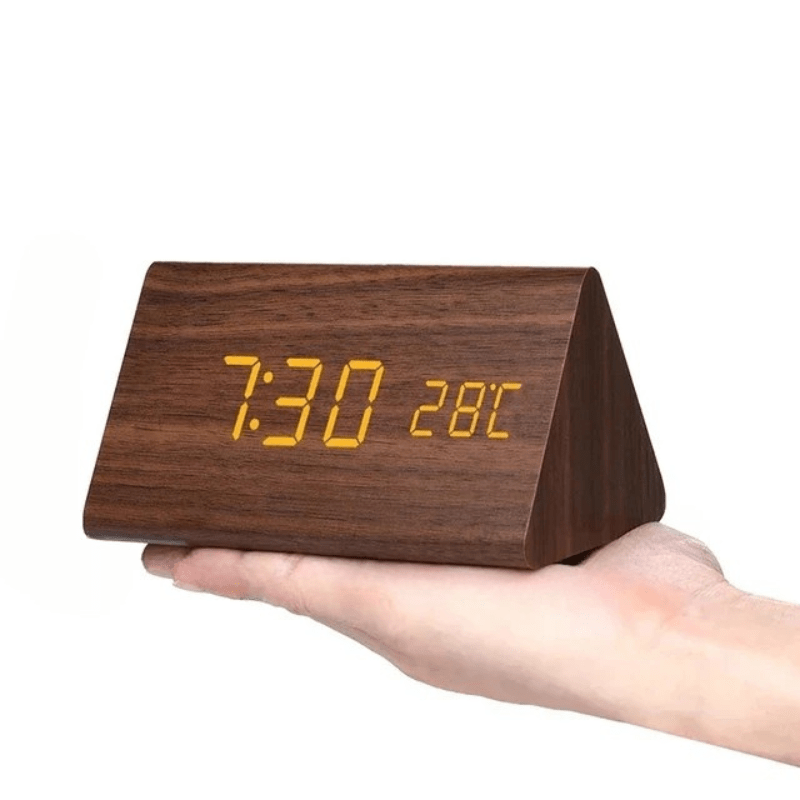 Triangular LED wooden clock showing digital time and temperature