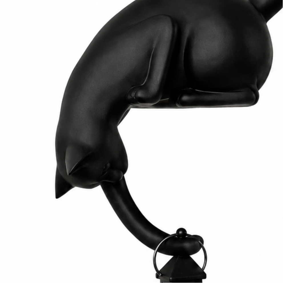Cat figurine perched on a shelf with a hanging LED lantern