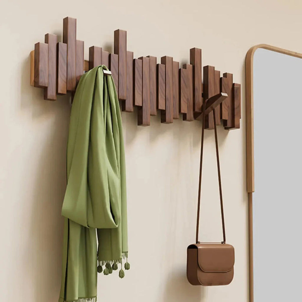 Wall-mounted slatted coat rack with folding hooks