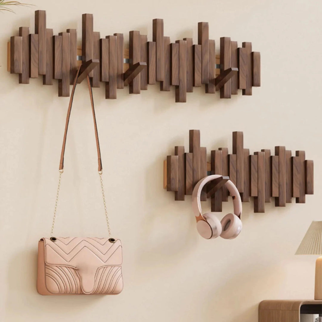 Wall-mounted slatted coat rack with folding hooks