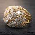 Gold-tone statement ring with textured bands and clear faceted stones