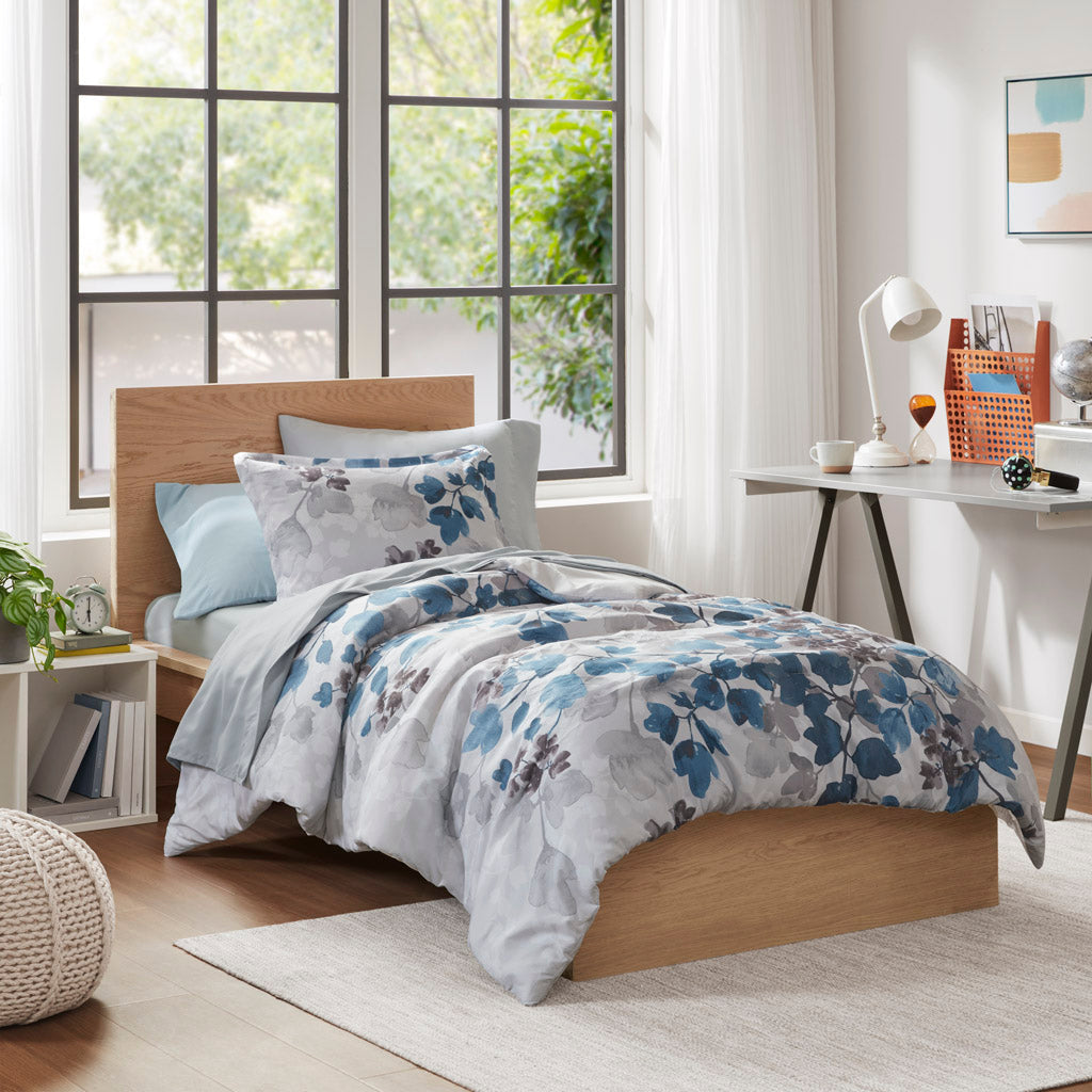 Floral comforter set with coordinating sheets and pillowcases on a bed