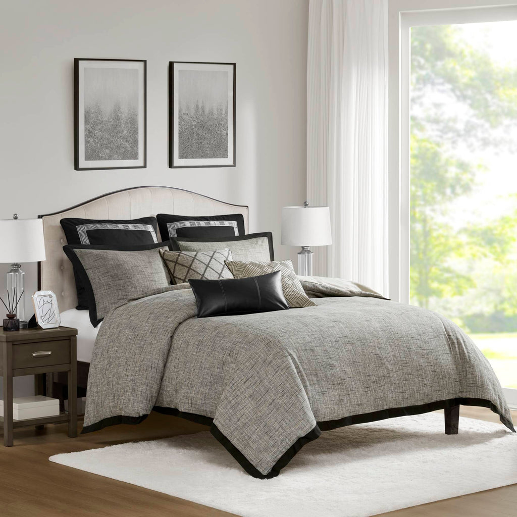 Grey textured jacquard comforter set arranged with geometric decorative pillows