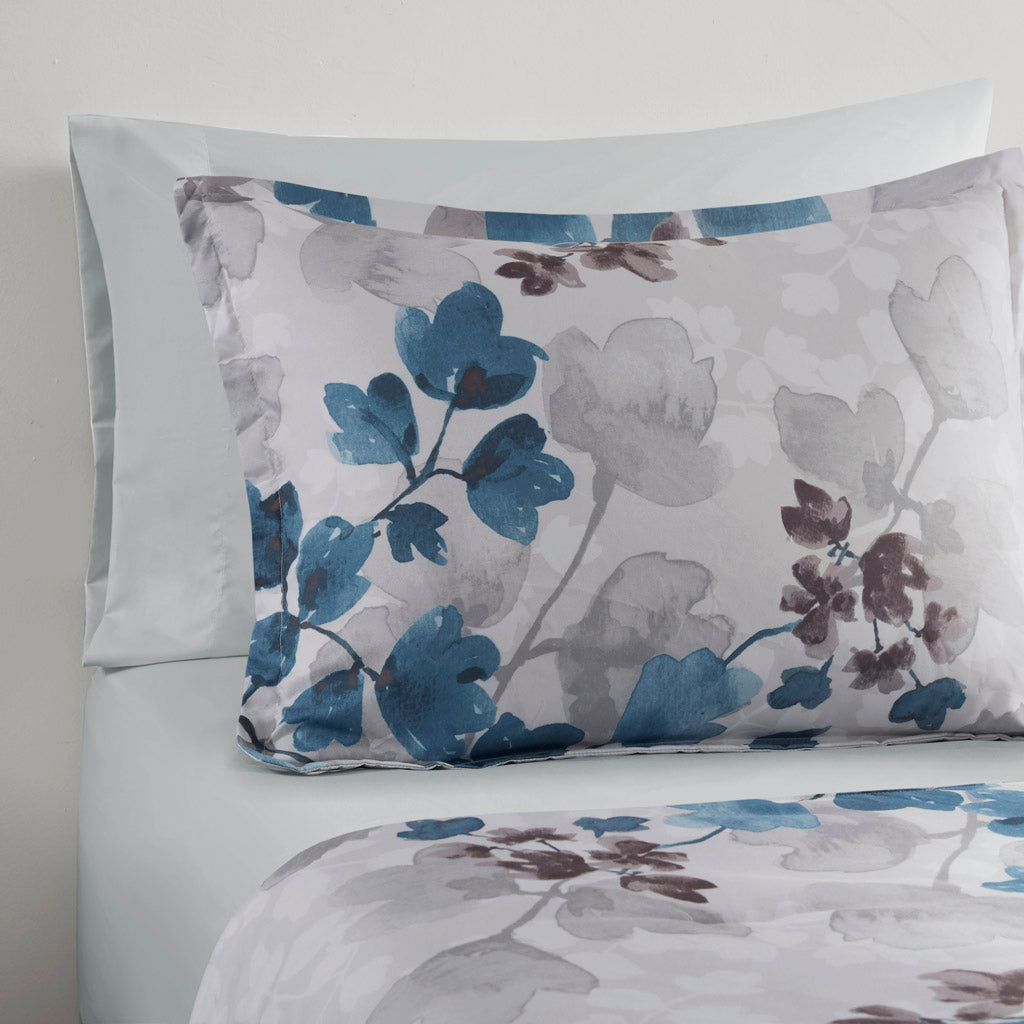 Floral comforter set with coordinating sheets and pillowcases on a bed
