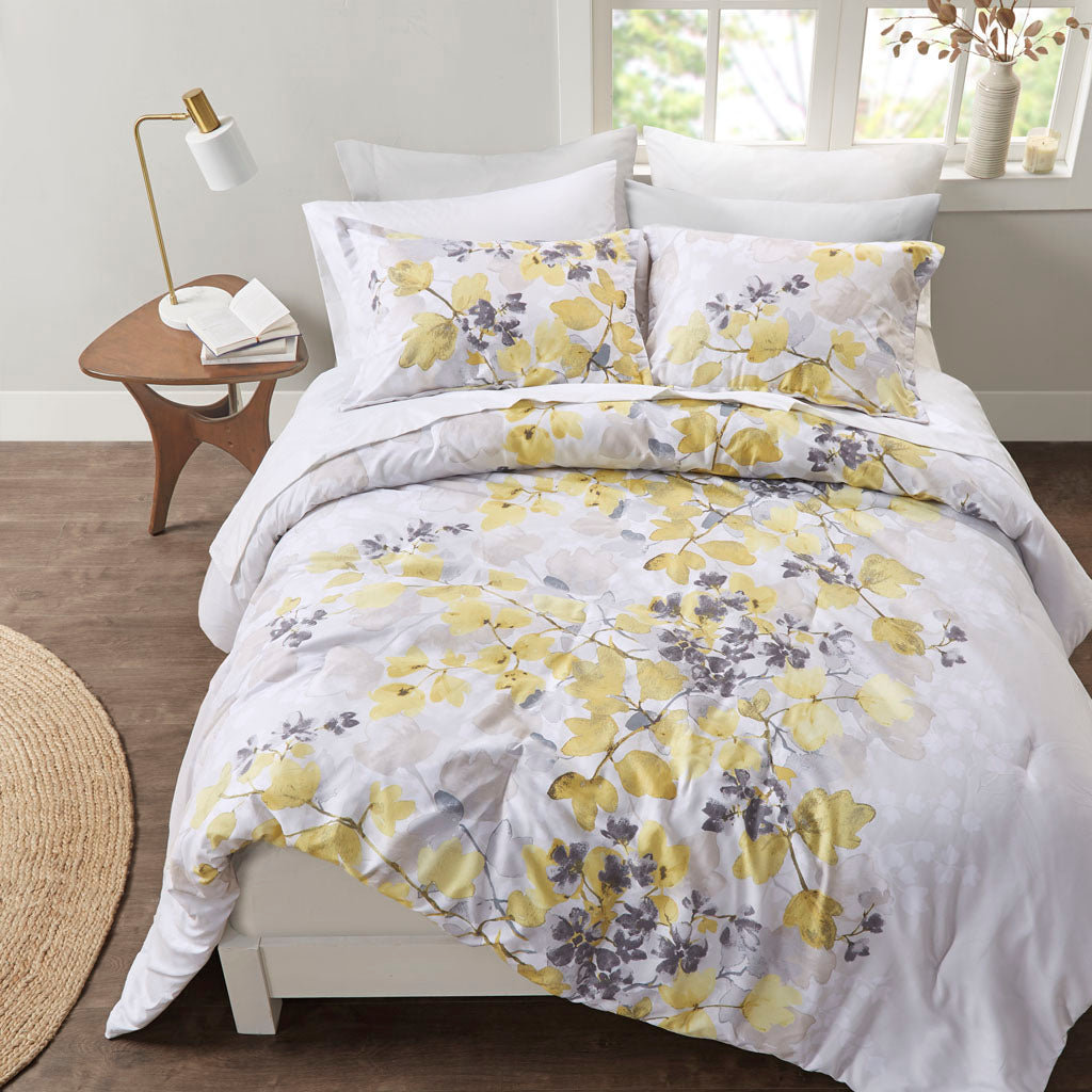 Floral comforter set with coordinating sheets and pillowcases on a bed