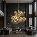 Tree branch pendant light with layered translucent leaf-style details and hanging chain