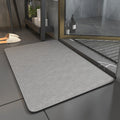 Rectangular bathroom mat with rounded corners and dark edging