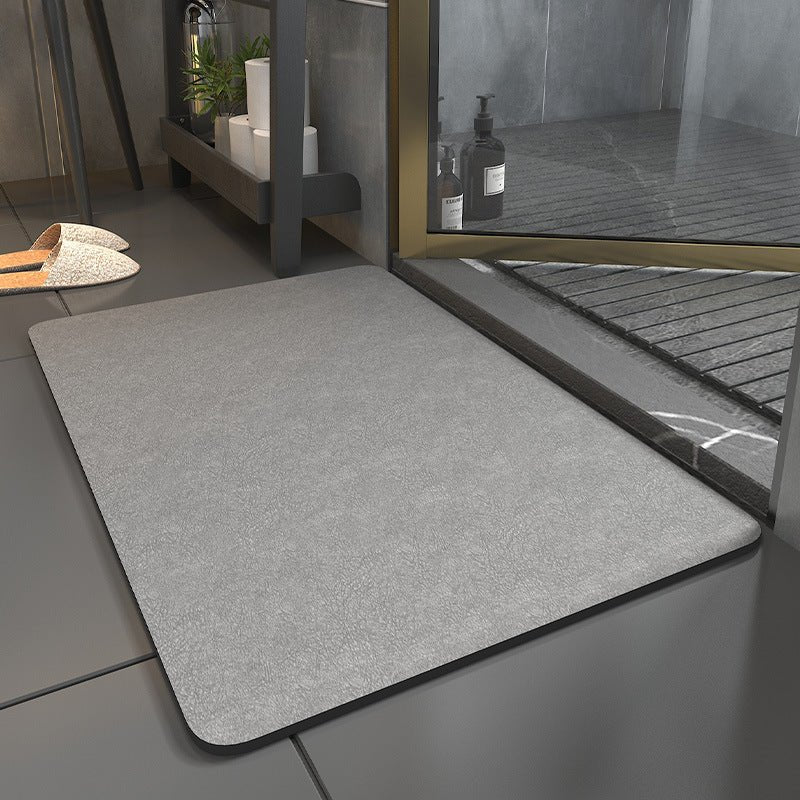 Rectangular bathroom mat with rounded corners and dark edging