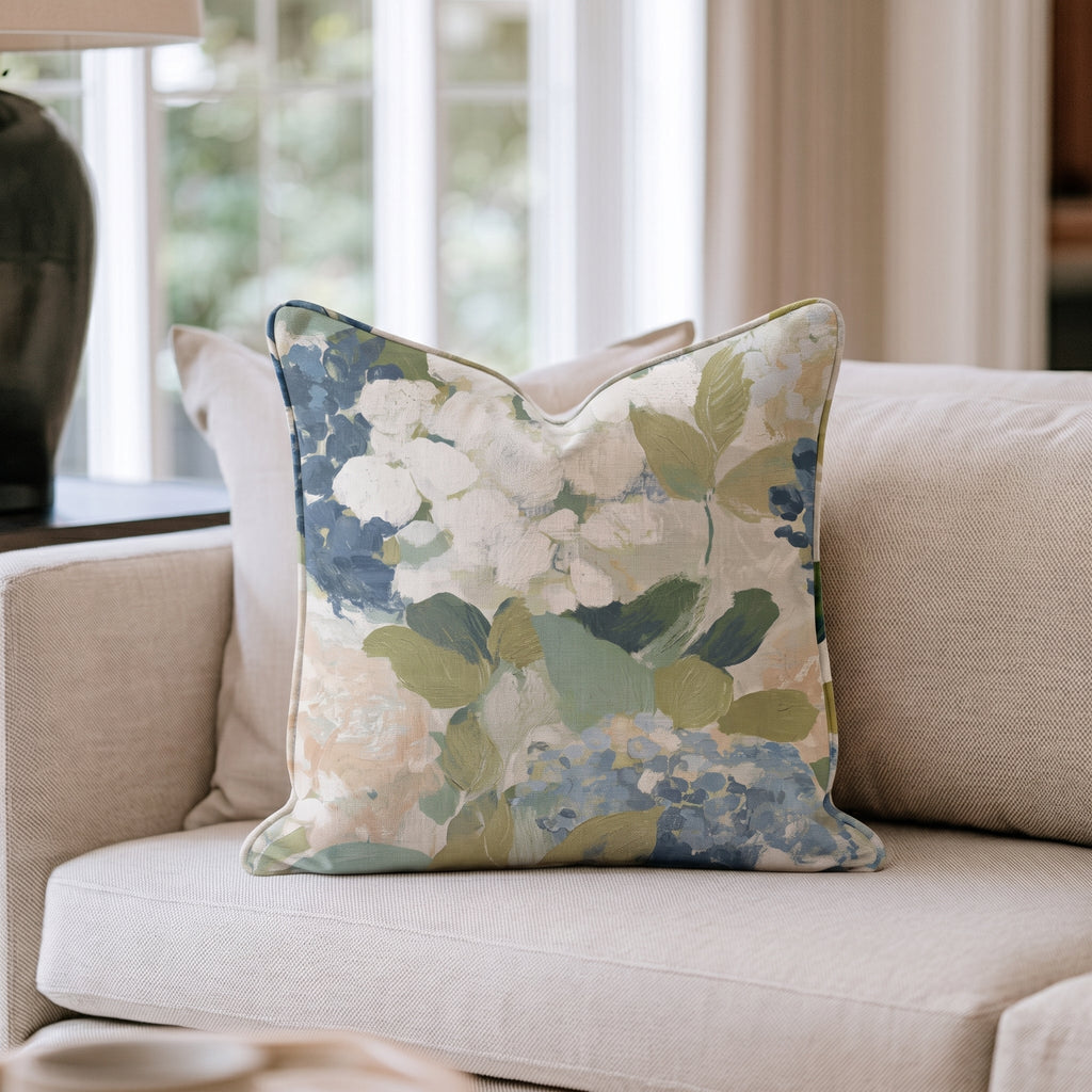 Blue floral throw pillow with botanical flowers and leaves