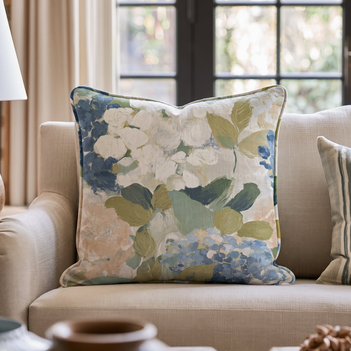 Blue floral throw pillow with botanical flowers and leaves