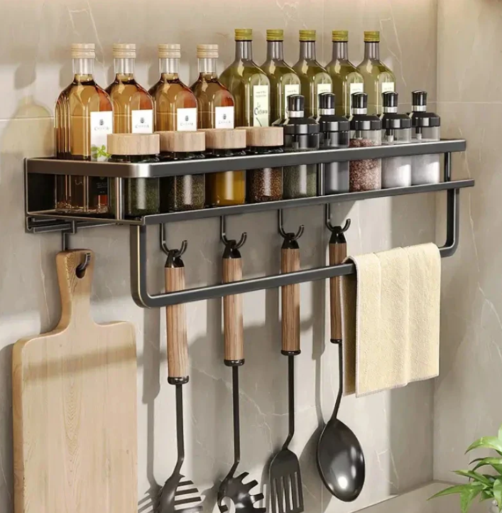 Black wall-mounted kitchen storage shelf with towel holder and utensil hooks