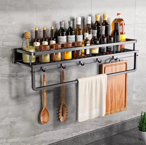 Black wall-mounted kitchen storage shelf with towel holder and utensil hooks