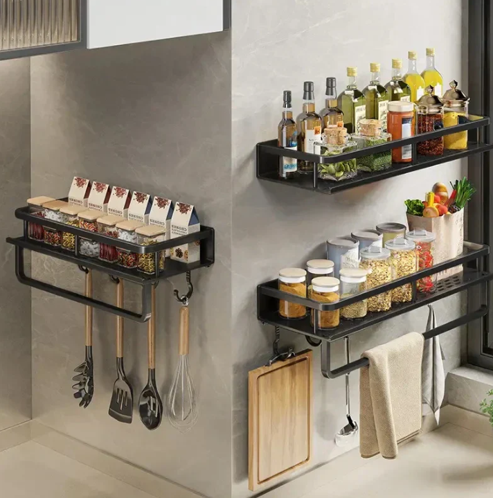 Black wall-mounted kitchen storage shelf with towel holder and utensil hooks