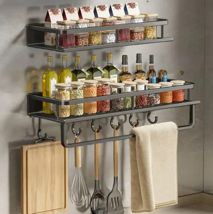 Black wall-mounted kitchen storage shelf with towel holder and utensil hooks