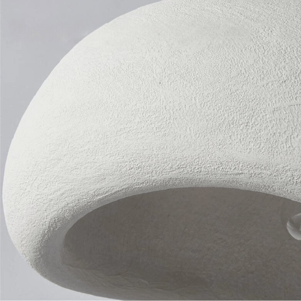 Curved dome pendant light with exposed bulb and warm glow