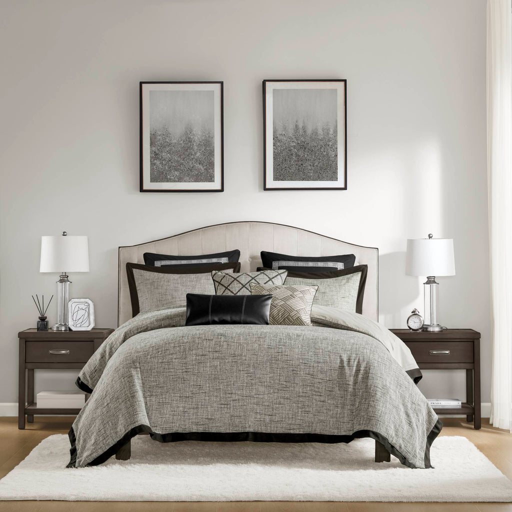 Grey textured jacquard comforter set arranged with geometric decorative pillows