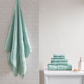 Six-piece textured bath towel set with decorative border detailing