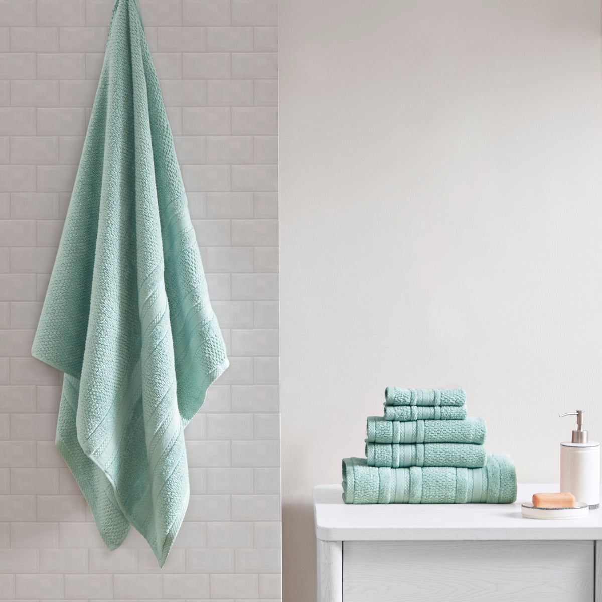 Six-piece textured bath towel set with decorative border detailing