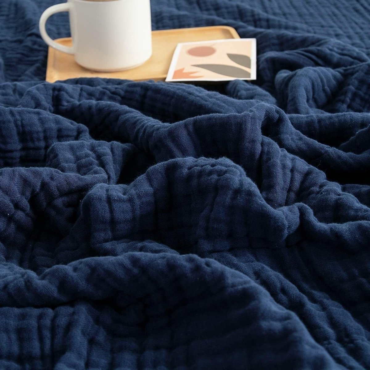 Textured wavy throw blanket draped over a chair