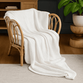 Textured wavy throw blanket draped over a chair