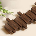 Wall mounted coat rack with staggered wood-effect pegs