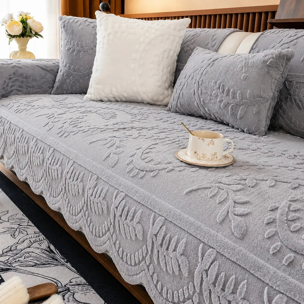 Plush sofa cover with raised botanical leaf texture and scalloped edge