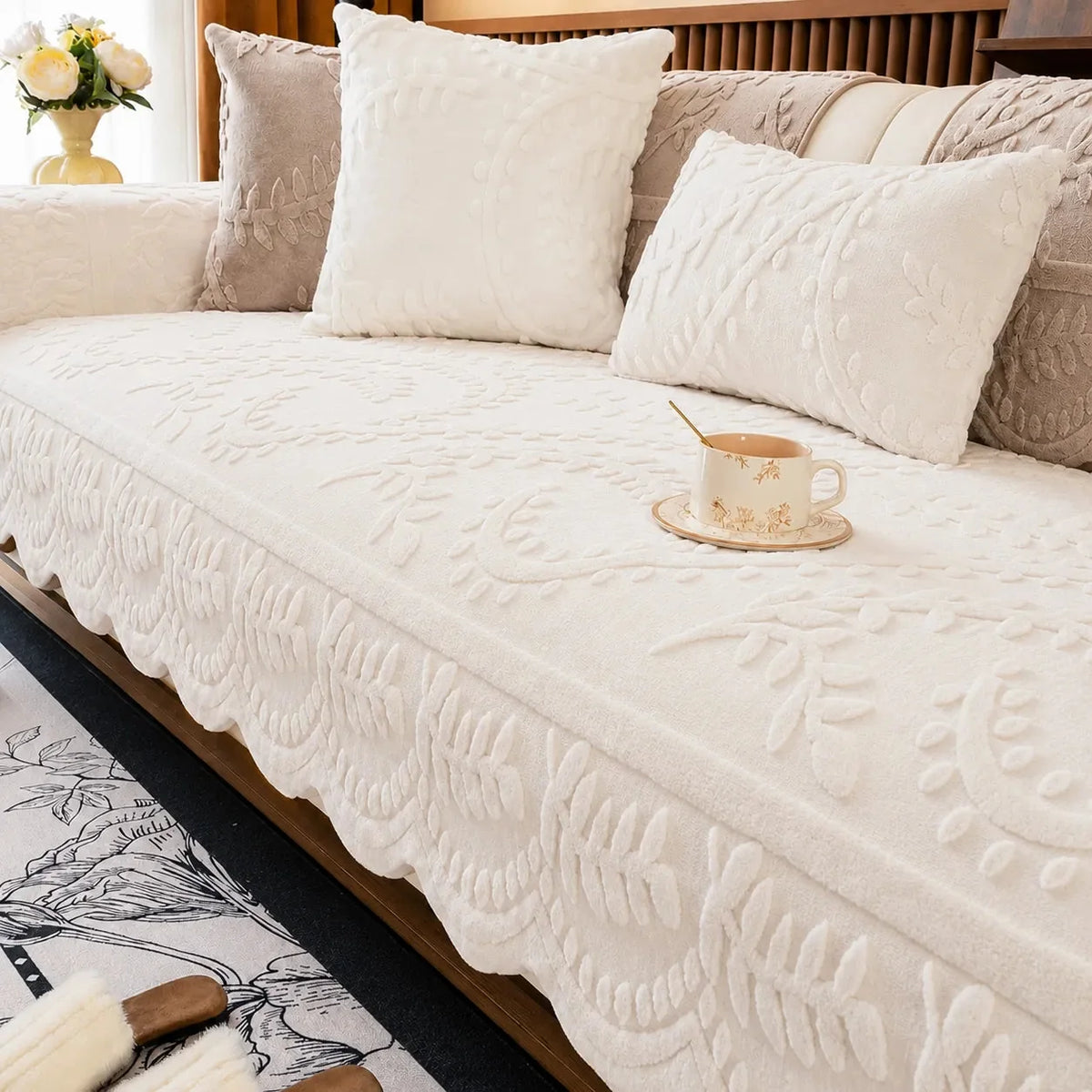 Plush sofa cover with raised botanical leaf texture and scalloped edge