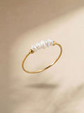 Gold-coloured pearl ring with white pearl detail