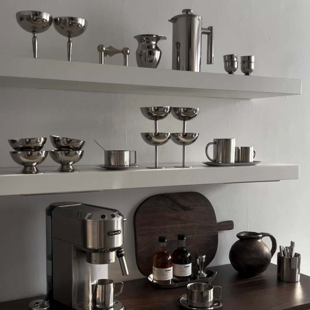 Silver stainless steel ice cream cup with a rounded bowl and pedestal base