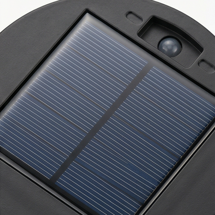 Black solar mandala projector light casting a geometric pattern outdoors