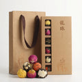 18 assorted blooming flower tea balls in a compartmented kraft presentation box with gift bag