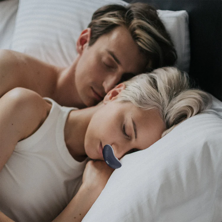 Compact CPAP machine with white nasal interface and side USB port