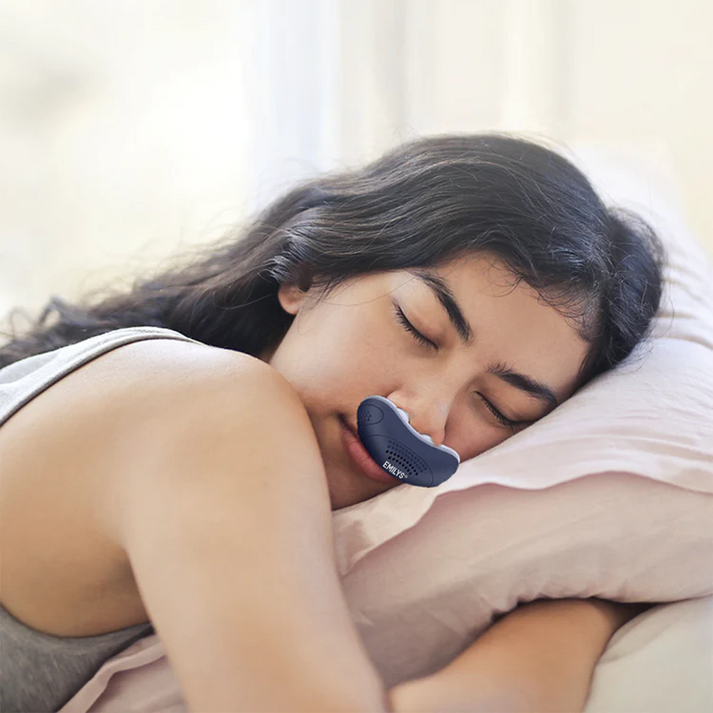 Compact CPAP machine with white nasal interface and side USB port