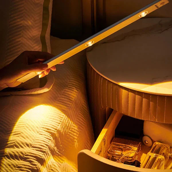 Wireless slim LED under cabinet light illuminating a kitchen worktop