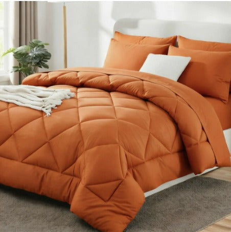 Quilted duvet with diamond stitching arranged over a bed
