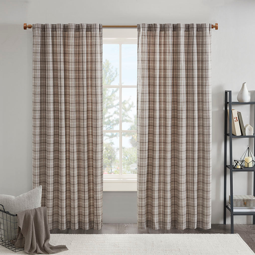 Plaid window curtain panels hanging from a curtain rod