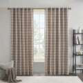 Plaid window curtain panels hanging from a curtain rod