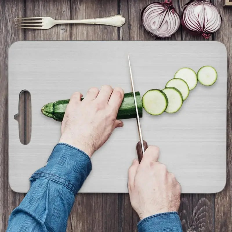 Brushed silver titanium chopping board with rounded corners and integrated handle opening