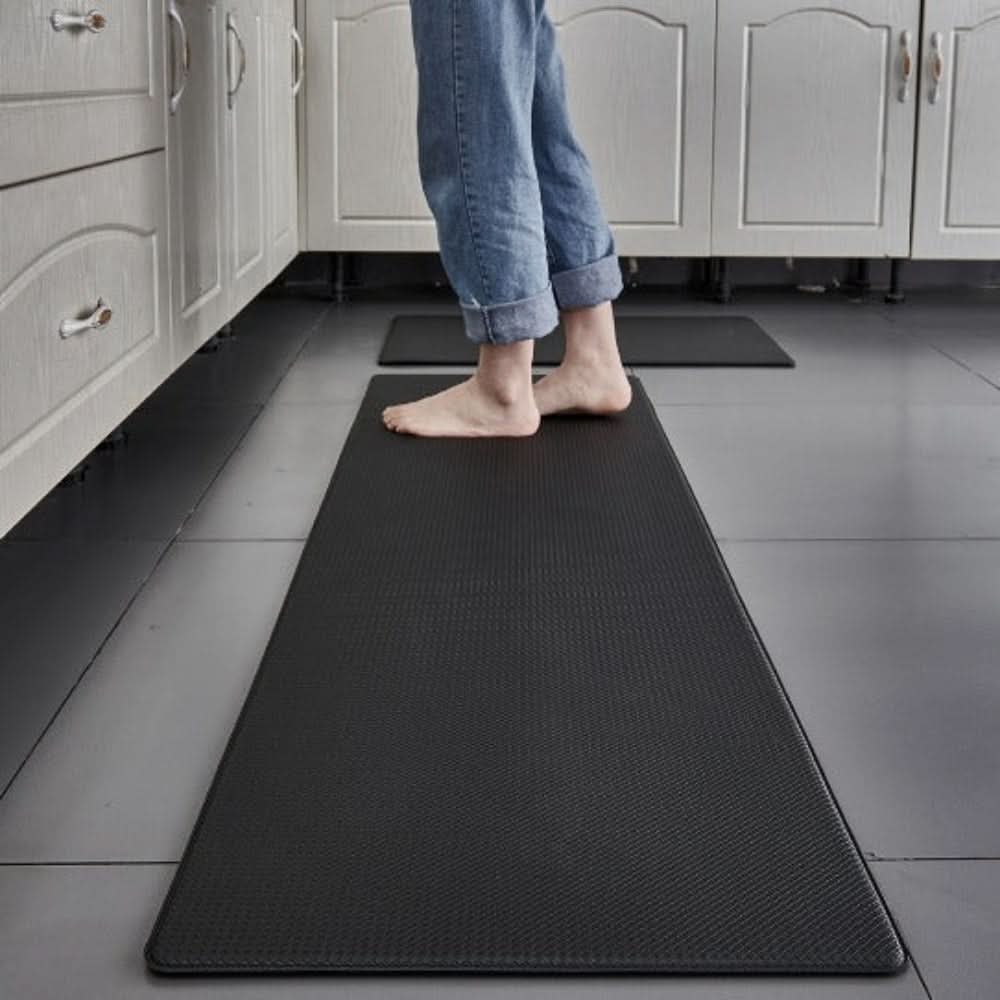 Textured rectangular anti-fatigue kitchen mat on a tiled floor