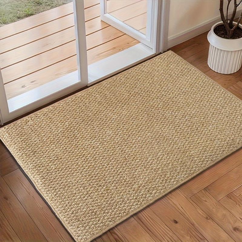 Textured beige rectangular non-slip door mat in an indoor entrance