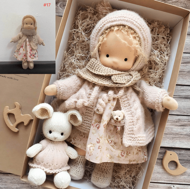 Handmade Waldorf doll in knitted clothing with soft features and character accessories