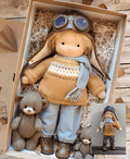 Handmade Waldorf doll in knitted clothing with soft features and character accessories