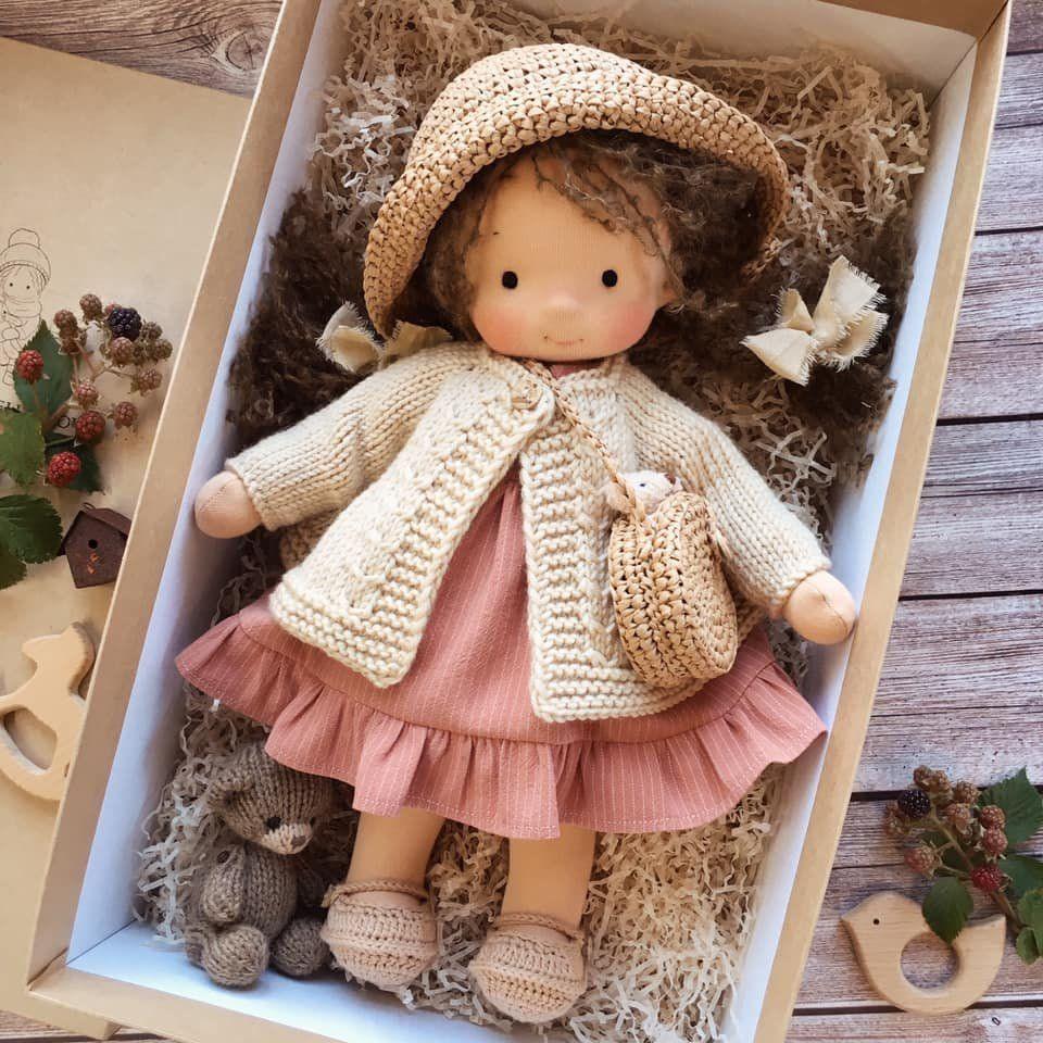 Handmade Waldorf doll in knitted clothing with soft features and character accessories
