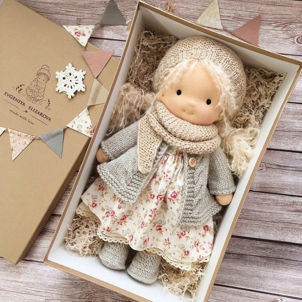 Handmade Waldorf doll in knitted clothing with soft features and character accessories