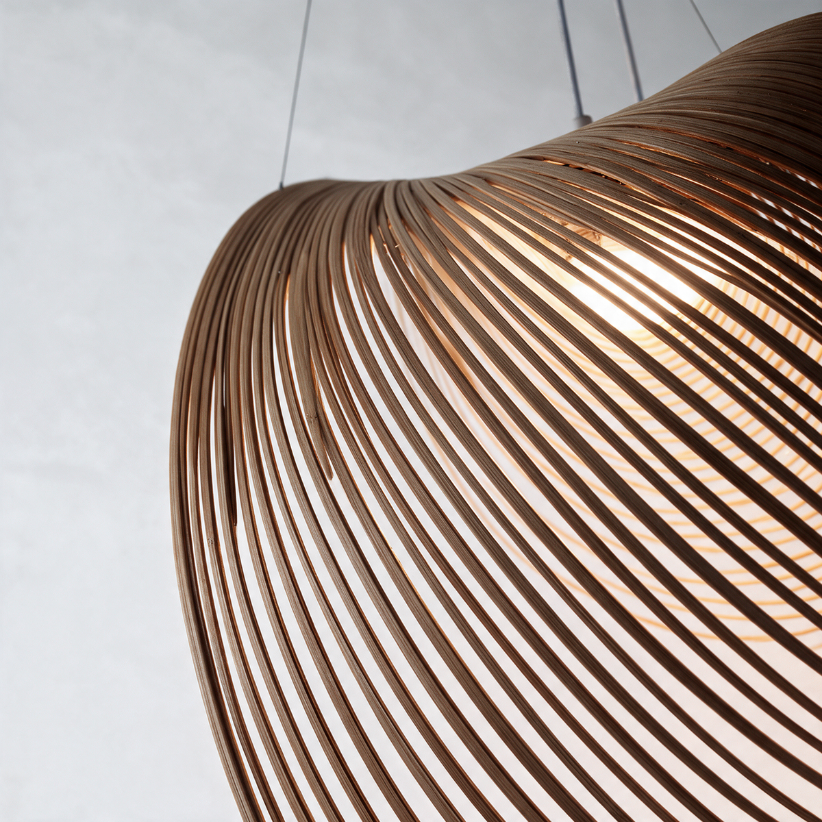Sculptural pendant light with a curved open wire shade