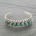Silver-toned open cuff bracelet with turquoise-effect stones and bead details