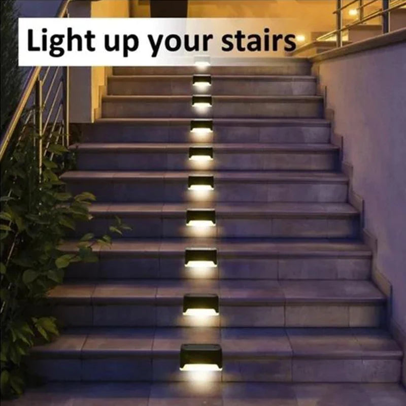 Black solar stair light illuminating outdoor steps and walls