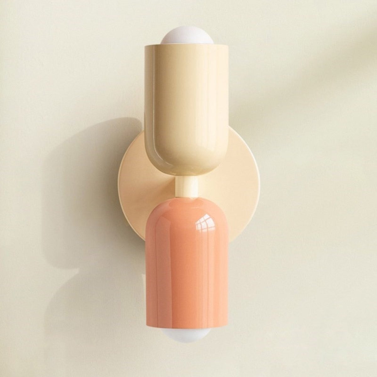 Decorative wall light with twin cylindrical shades and round backplate
